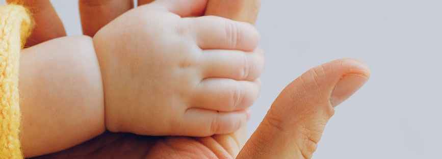 person holding babys hand